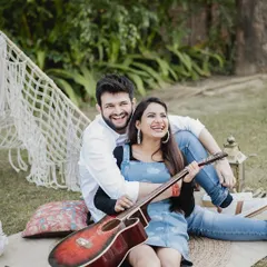 A fun, candid moment during a picnic-themed shoot. Using props like a guitar allows the couple's personality to shine through, resulting in photos that are both beautiful and uniquely them.