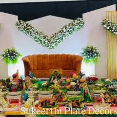 This puberty ceremony setup in Annur features a modern stage design. My traditional platter arrangements in the front provide a beautiful contrast and a connection to our culture.