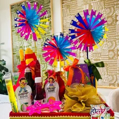 A full view of the nostalgic Holi hamper. It's a burst of joy, featuring a sweet box wrapped in organza, a potli of dry fruits, thandai, sherbet, and fun quirky glasses, all packed into a festive tray that screams 'Holi Hai!'.