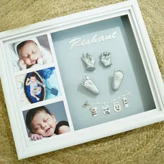 For a clean and classic look, I created this piece for baby Rishant with silver casts on a soft grey background. The design incorporates three of his newborn photos alongside his name and adorable hanging birth stat charms.