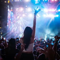 A sea of phones and hands in the air, capturing a magical moment under the blue and purple lights of a Martin Garrix show.