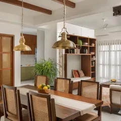 For the Reddy Home, we designed a dining area that blends neo-traditional elements with modern comfort. The custom teak dining set, antique brass lighting, and a reclaimed wooden column create a warm, inviting space for family gatherings.