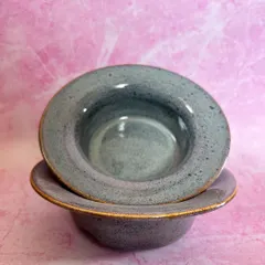 Two pasta bowls stacked, showing their uniform shape and the subtle variations in the glaze.