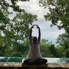 Raising the arms during a seated meditation can help to open the heart and lengthen the spine. This movement encourages a feeling of receiving energy from above while staying grounded through your seat. It is a beautiful way to connect the earth and the sky within your own body.