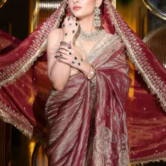 This shot captures the flow and elegance of the saree. The makeup is kept sophisticated with a flawless base and defined eyes, letting the outfit and the wearer's confidence shine.