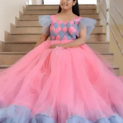 Here's a look at one of our custom-designed ball gowns, worn by the lovely Suguna. The unique pink and grey checkered bodice and full tulle skirt make it a real showstopper for any event or portfolio shoot.