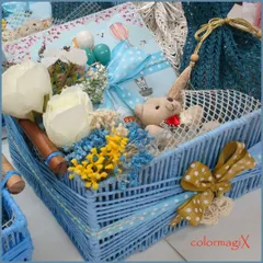 A beautiful baby boy hamper in a woven blue basket. This gift is carefully assembled with a teddy bear, floral accents, and other newborn essentials, all tied together with a charming blue polka-dot ribbon.