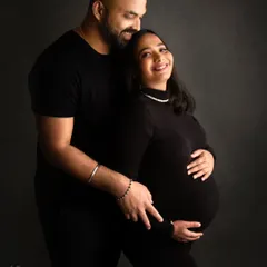 A sleek and modern couple's portrait. Dressed in all black, these parents-to-be create a powerful and timeless image of their journey together.