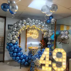 We love creating these impressive setups for office birthdays. The combination of a metallic balloon ring, large light-up marquee numbers, and a neon sign makes any employee feel truly celebrated by their company.