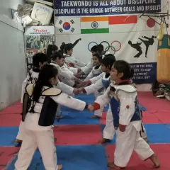 A fist bump line before practice, building camaraderie and team spirit among our little fighters.