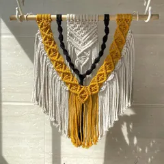 Another shot of the layered macrame wall hanging, capturing the beautiful shadows created by the sunlight. All our pieces are made with high-quality, sustainable cotton cord.