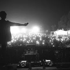 A powerful black and white shot showing the sea of lights from the crowd. This is the AfterLifeFam lighting up the night at Escapeland Festival.