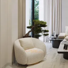 A close-up of the textured bouclé armchair and bonsai tree, details that bring organic warmth and a touch of nature into this modern living space.