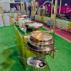 A close-up of the ornate, hammered-gold serving dishes used at my Mughlai counter, adding a touch of royalty to the buffet.