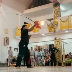 Another look at weapons practice during a training session. Here, I am demonstrating a specific technique with the Jian sword, focusing on control and intent for my students.