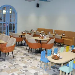 Our cafe offers a mix of seating options, including adult-sized tables and colorful, kid-sized tables for little ones who need a snack break.