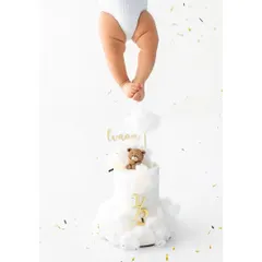A creative and artistic shot for a half birthday celebration. The focus on the tiny feet dangling over a beautiful milestone cake creates a unique and memorable image.
