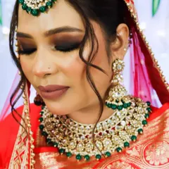 This angle showcases how the makeup, jewelry, and hairstyle come together. I focused on creating a strong contour to define her features and used a warm, matte lipstick that perfectly matched the undertones of her bridal lehenga.