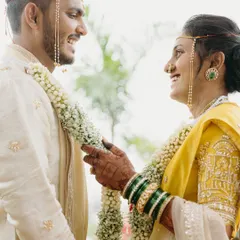 During their Maharashtrian wedding, Pratik and Yamini share a look of pure happiness. This candid portrait captures the essence of their eight-year journey, a friendship that blossomed into forever.