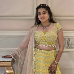 A soft pastel yellow lehenga is a wonderful choice for daytime events. This one features a beautifully embroidered blouse with pearl details and a lightweight skirt for comfort.