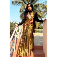 A full-length view of the copper-brown tissue cotton saree. The rich color and lustrous texture make it a true statement piece for any celebration.