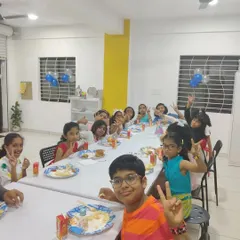 Making memories together at a fun-filled birthday art party. The kids are enjoying some snacks after finishing their awesome creations.