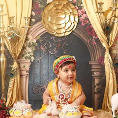 This older baby is full of smiles in our grand Krishna setup. The ornate candelabras, golden curtains, and traditional props create a truly majestic scene for his Janmashtami shoot.