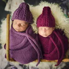 Coordinated and cozy in matching purple and magenta knit hats and wraps. This overhead shot in a basket shows how I style twins to create a beautiful, harmonious portrait.