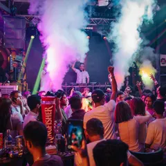 The view from my console at Happy Brew, with smoke effects adding to the atmosphere. Creating a full sensory experience with lights, effects, and music is key to my DJ sets.