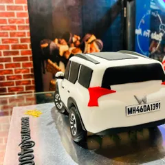 The rear view of the sculpted XUV400 cake, showing the detailed taillights and custom number plate.