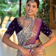 A beautiful smile from a model wearing a grand oxidized silver set with green stones. This is a perfect example of how to style traditional jewellery for a modern event.