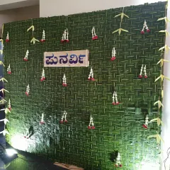 A full view of the traditional naming ceremony backdrop made from woven coconut leaves, with a custom Kannada nameplate.