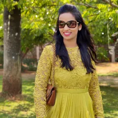 A close-up of Devika in her vibrant yellow lace dress, a perfect outfit for a sunny day out.