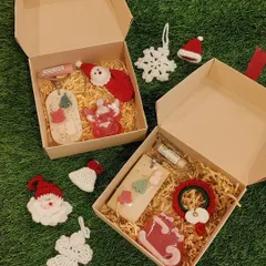 My Christmas collection of ornaments and bookmarks going out in festive hampers. This shows two gift boxes ready to be sent.