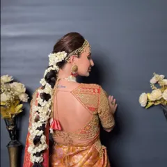 Another angle of the magnificent floral braid, showcasing the intricate weaving of the flowers into the hair for a lush and fragrant bridal statement.