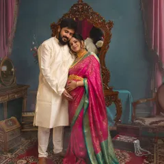 A tender moment between partners in a setting that feels like a royal chamber. The classic attire and warm lighting highlight the couple's deep connection as they await their new arrival.