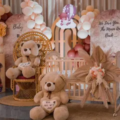 A closer look at the details of the teddy bear naming ceremony. The custom backdrops, baby crib prop, and pampas grass arrangements add a touch of boho elegance.