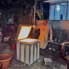 This is the moment of transformation. I am opening the kiln during a Raku firing session, where intense heat and sudden cooling create beautifully unpredictable patterns. It's a process that's as much about letting go as it is about control.