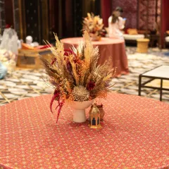 A beautiful centerpiece for a rustic-themed event. I used dried florals and pampas grass in an earthy color palette to create a textured and sophisticated arrangement for the guest tables.