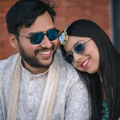 A sweet, candid moment between the couple during their Haldi. Their matching smiles and sunglasses show their fun-loving connection.