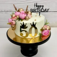 Another view of the 50th birthday cake, showing the beautiful combination of fresh flowers and metallic accents.