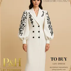 A vision of modern regality, this image showcases a model in a pristine white, double-breasted dress. The design is distinguished by its dramatic puff sleeves adorned with intricate black floral embroidery, creating a powerful silhouette that is both elegant and commanding.