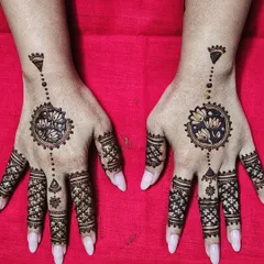 Another variation of a mandala design. This one features a floral mandala with delicate dotted lines extending towards the wrist.