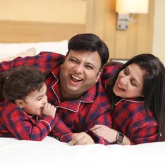 The best family portraits are the ones filled with genuine laughter. This candid moment of a family sharing a laugh in their matching pajamas captures the warmth and connection that I strive for in every family photoshoot.