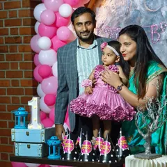 A family portrait from a 'Love You to the Moon and Back' themed first birthday. Seeing our clients happy in the beautiful setting we created is our ultimate goal.