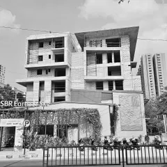 Black and white site photos documenting the construction of the SBR Earth & Sky project in Bangalore, capturing the raw concrete structure and powerful forms.