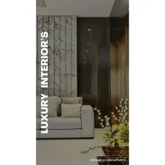 A detail shot showcasing the contrast between vertically paneled white marble and a dark, polished wood wall. This juxtaposition of materials is a hallmark of our approach to creating visual interest and luxury.