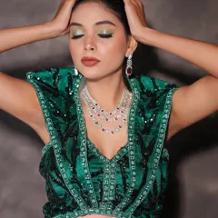 A close-up of the glam look, showing the green shimmer eyeshadow and bold lip.
