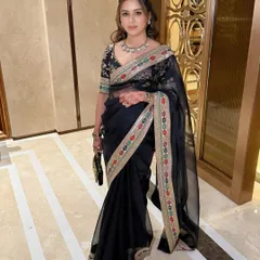 A full-length shot of the elegant black saree look, perfect for a reception or evening party.