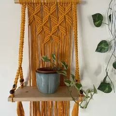 Here is my macrame floating wall shelf in a bright and sunny mustard yellow. It's a wonderful way to display a small plant and add a pop of color to your wall.